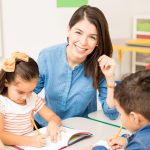 portrait-gorgeous-hispanic-preschool-teacher-teaching-her-students-classroom